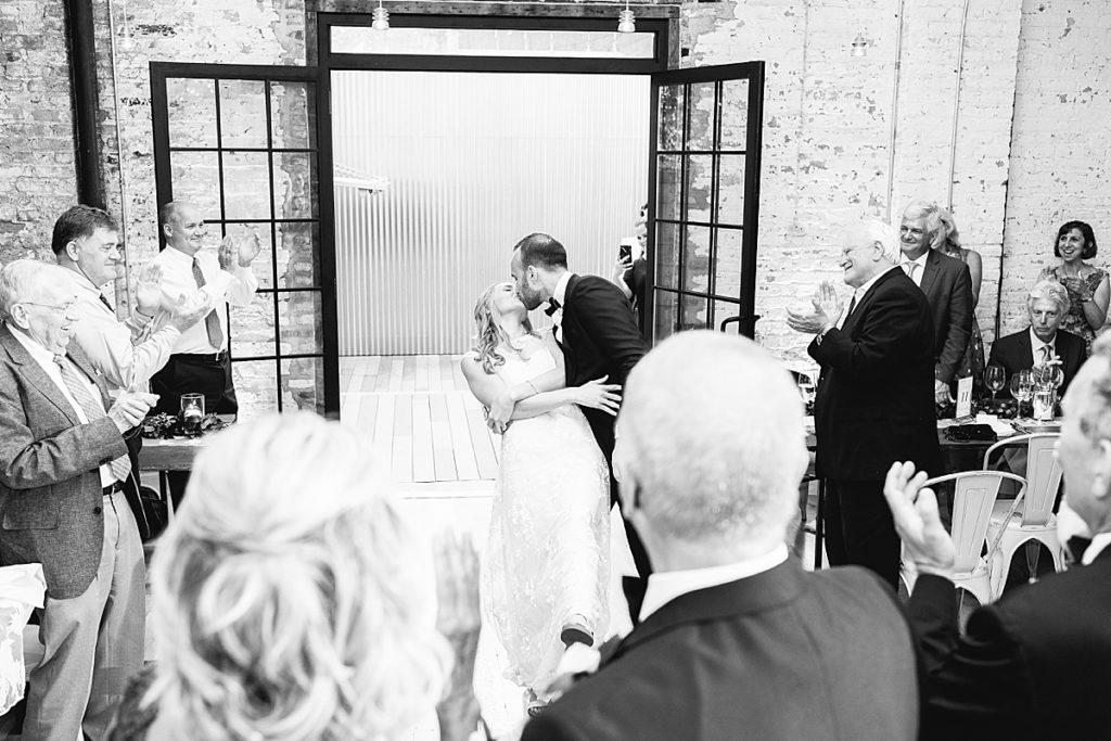 Bride and groom enter the space and kiss