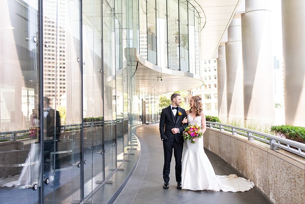 Couple poses along the Chicago River walk outside of the Trump Hotel