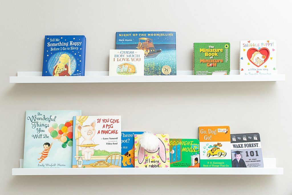 Childrens book line the shelves in this nursery
