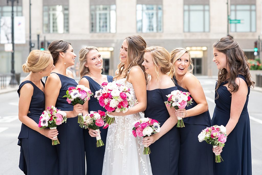 The bridesmaids had colorful bouquets similar to the brides