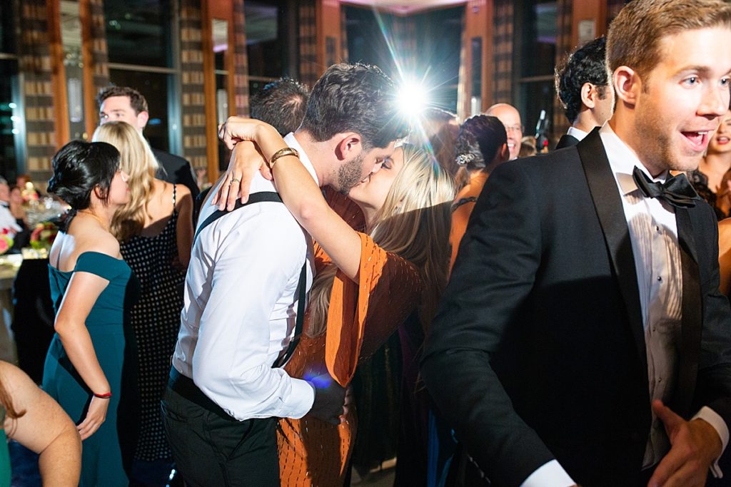 Groomsmen kisses his girl on the dance floor