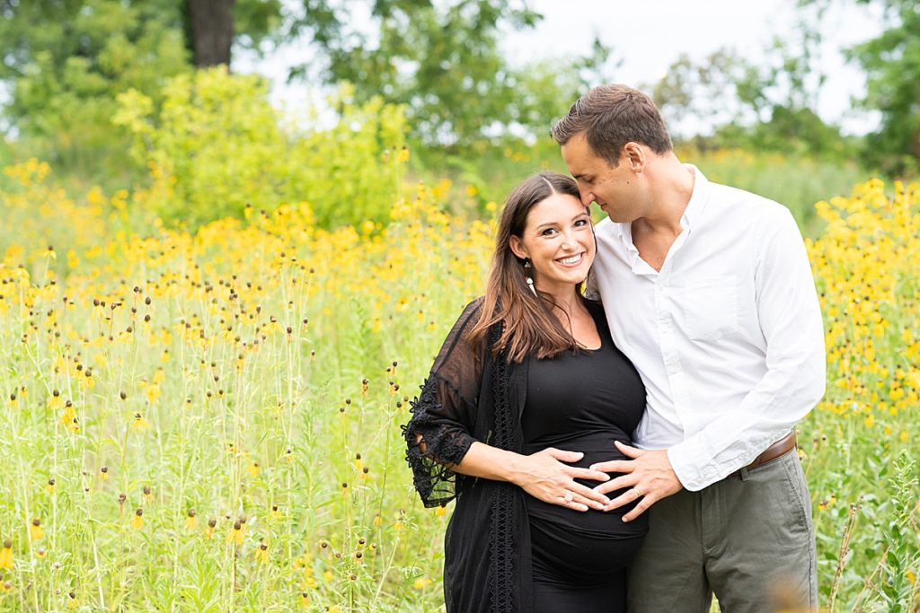 Blooming yellow flowers provide a beautiful backdrop for a smiling couple