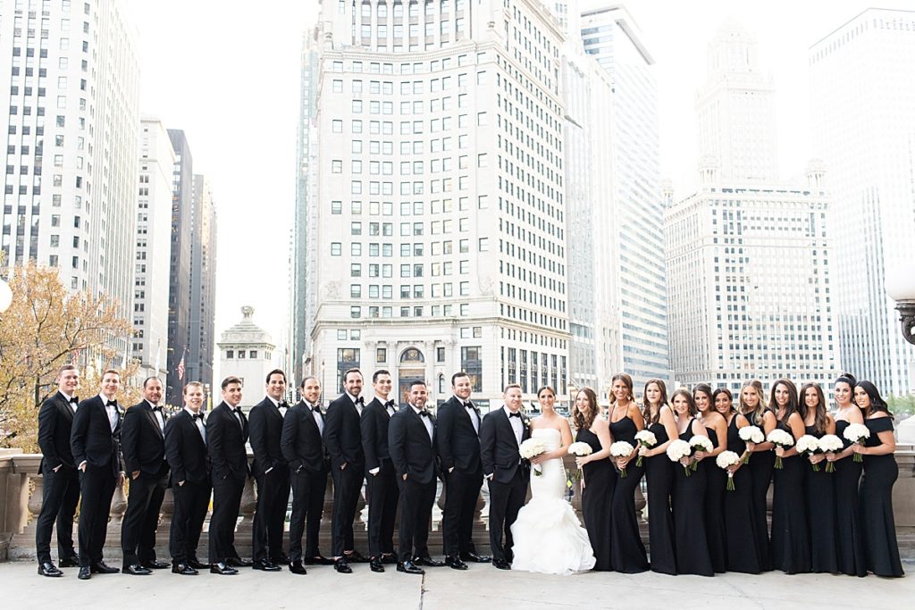 All black bridal party poses along the river