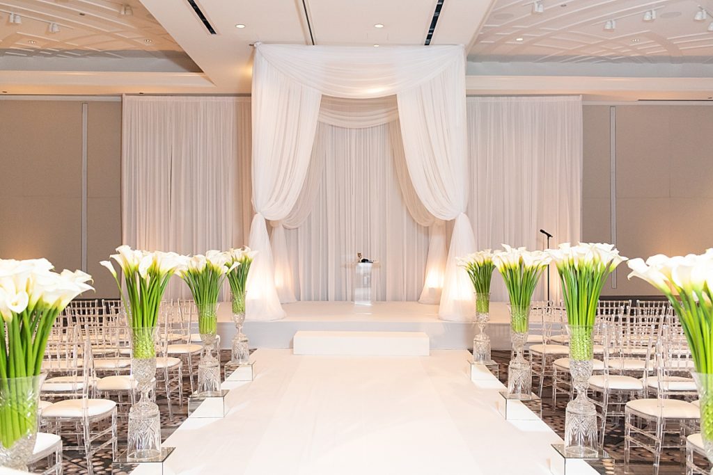All white ceremony space with a pop of color