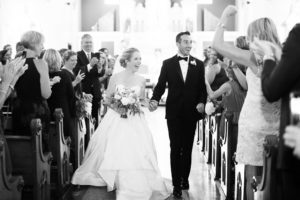 husband and wife walk down aisle