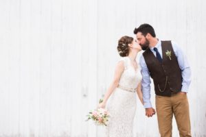 White barn bride and groom