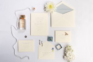 Detailed photo of light blue invitations and bridal accessories