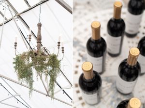 chandelier with greenery and close up of red wine bottles