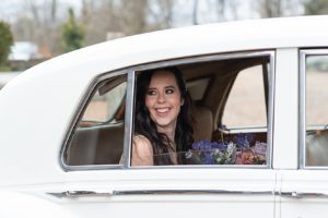 Bride in white car before wedding