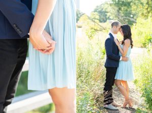 Man and woman posing for engagement photos in Lincoln Park. In one image, the shot is of the man and woman holding hands while facing each other. The shot is from the waist down. In the other image, the man and woman are facing each other and embracing and their entire bodies are visible.