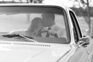 Couple kissing in old Chevy truck (black and white photo)