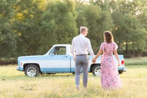 Man and woman with their backs to the camera in front of Vintage Chevy truck in Shelby Farms Park in Nashville, Tennessee