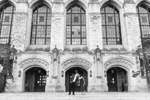 black and white photo of couple kissing on the stairs of a grand building on Northwestern University's campus