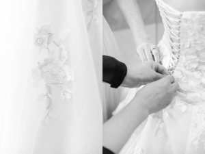 Close up of bride getting laced into wedding dress