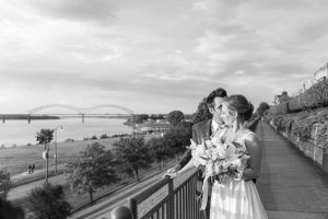 Bride and groom posing with the Memphis skyline in the background