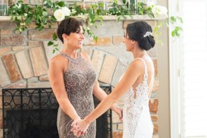 Photo of a bride in her wedding dress with her mother