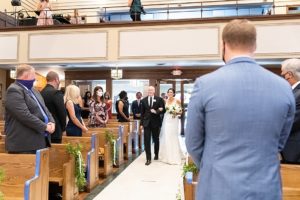 Photo of bride walking down the aisle with her dad in St. Patrick's Catholic Church in St. Charles Illinois.