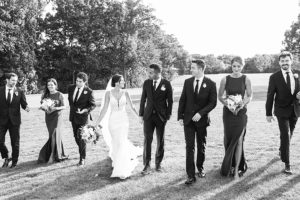 photo of bridal party walking towards the camera