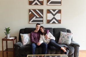 Man and woman posing for engagement photos in their Chicago apartment
