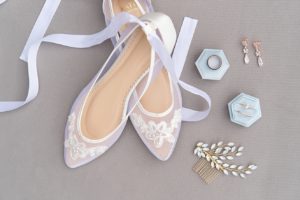 Wedding day details featuring lace bridal ballet flats