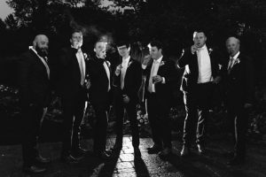 The groom and groomsmen smoked cigars at the wedding reception