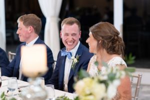 Bride and groom smile at each other during wedding reception