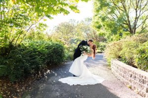 Bride and groom posed for a kiss and dip photo at the Botanical Gardens