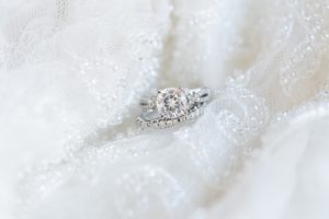 Close up photo of engagement ring and wedding band