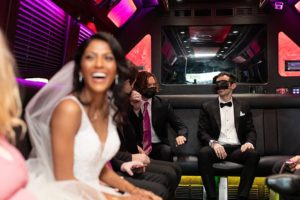 bride and groom having fun in the wedding limo