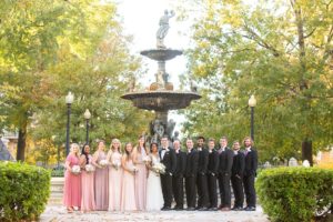 Bridal party poses for wedding photos outdoors