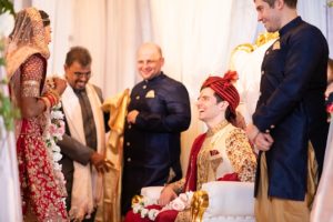 bride and groom with wedding guests at traditional Indian wedding
