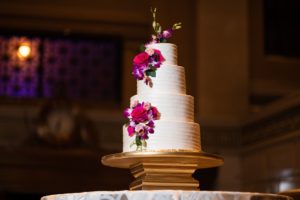 large four-tier wedding cake with flower accents