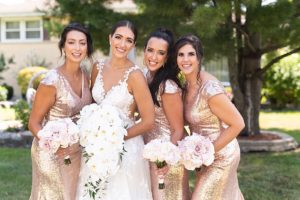 the bride posed with her bridesmaids in gold dresses